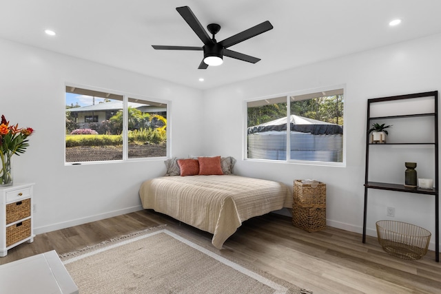 bedroom with light wood-type flooring and ceiling fan