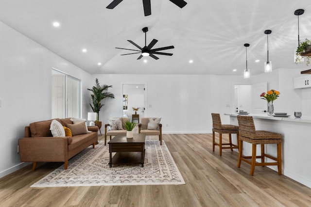 living room featuring light hardwood / wood-style flooring and vaulted ceiling