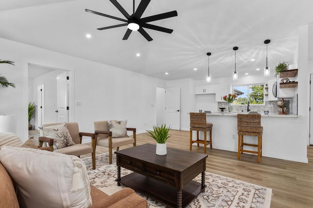 living room featuring light wood-type flooring and ceiling fan