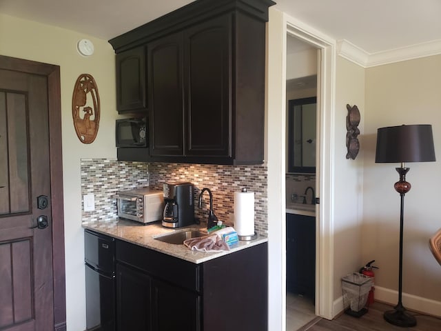 3811 Edward Rd Unit 1202, Princeville, HI 96722 - kitchen with a sink, black appliances, tasteful backsplash, baseboards, and crown molding