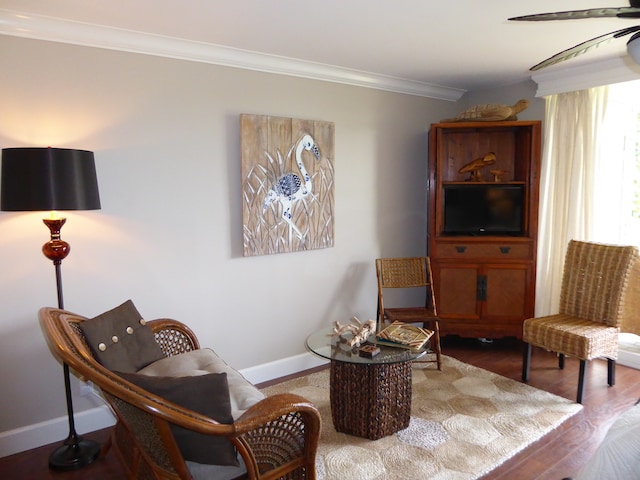 living area featuring ornamental molding and hardwood / wood-style flooring