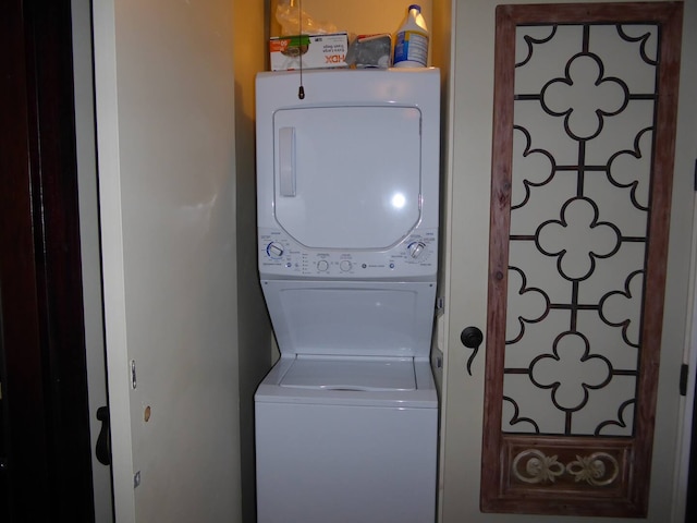 laundry area with stacked washer and dryer