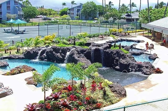 view of pool featuring tennis court