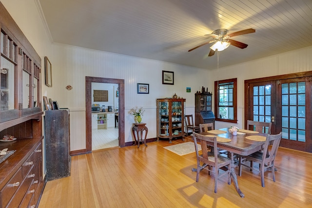 dining area with ornamental molding, french doors, light hardwood / wood-style flooring, and ceiling fan