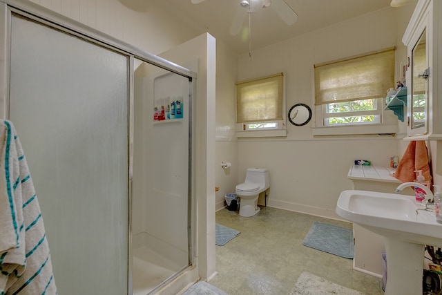 bathroom with toilet, an enclosed shower, and ceiling fan