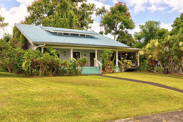 view of front of home with a front yard and covered porch