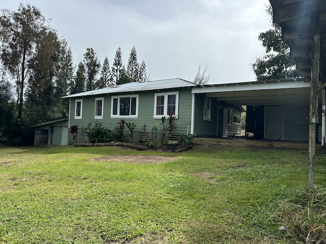 view of front facade with a carport and a front yard