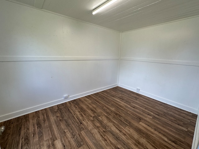 unfurnished room with dark hardwood / wood-style flooring