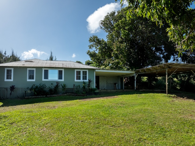 ranch-style home with a front yard and a carport