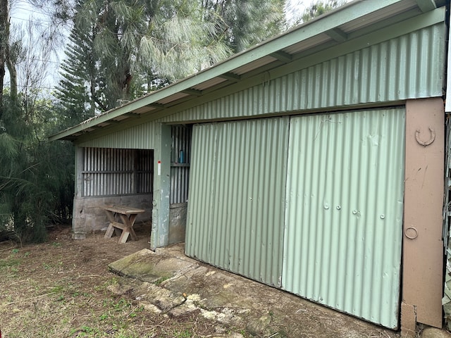 view of home's exterior with an outbuilding