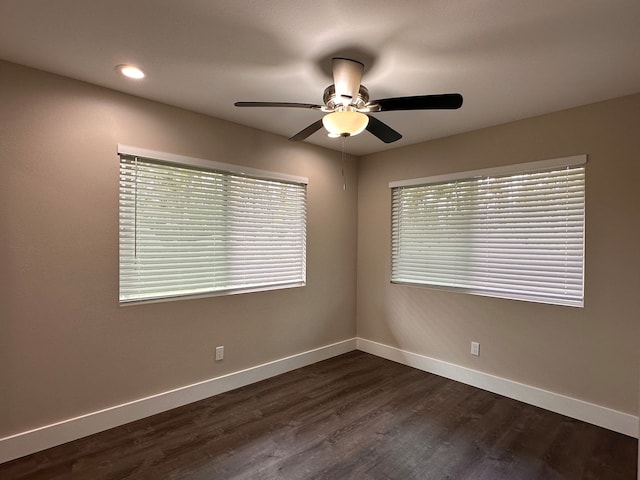 unfurnished room with dark wood-type flooring and ceiling fan