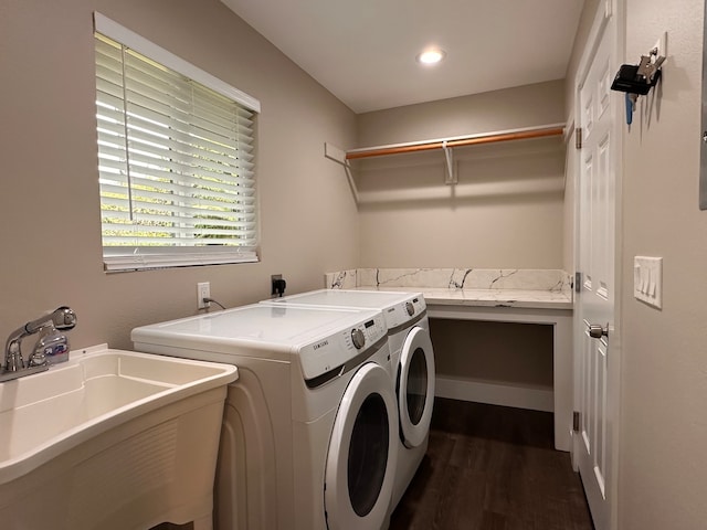 laundry room with sink, washer and dryer, and dark hardwood / wood-style flooring