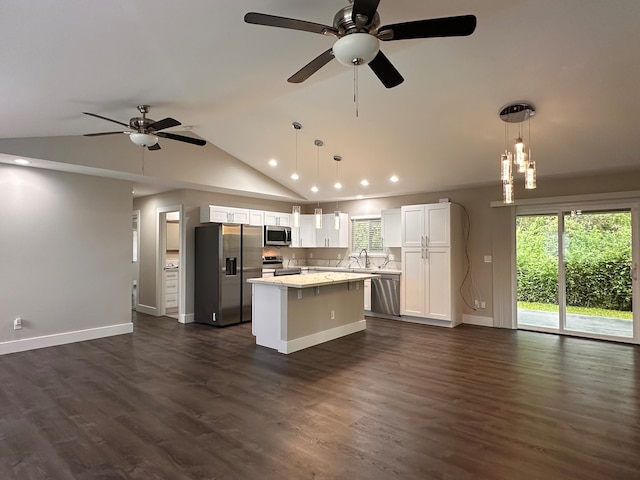 kitchen featuring white cabinets, stainless steel appliances, dark wood-type flooring, and a kitchen island