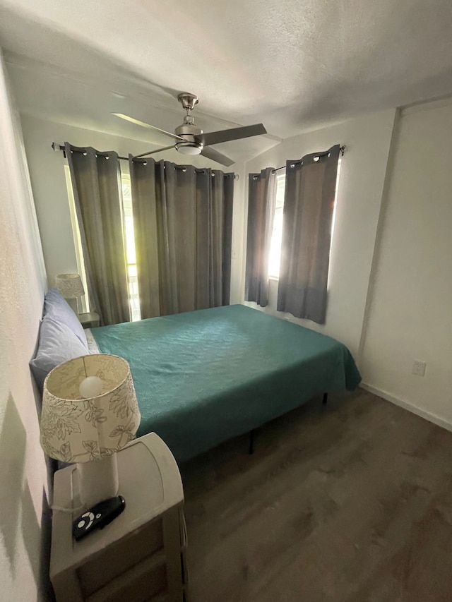 bedroom featuring ceiling fan and a textured ceiling