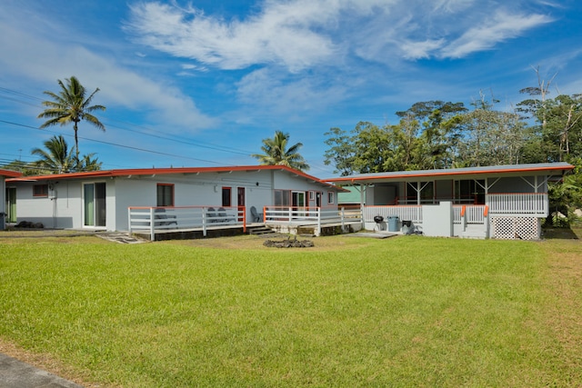 rear view of house featuring a yard