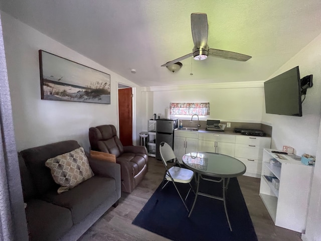 office space featuring lofted ceiling, sink, dark wood-type flooring, and ceiling fan