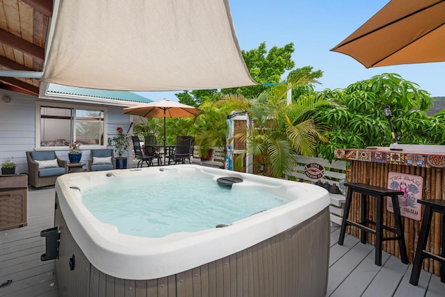 wooden deck with a hot tub