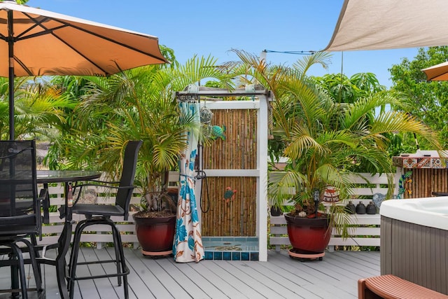 wooden terrace featuring a hot tub and central AC unit