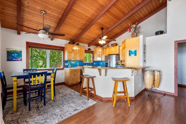 kitchen with kitchen peninsula, wooden ceiling, a breakfast bar, dark hardwood / wood-style floors, and stainless steel refrigerator with ice dispenser