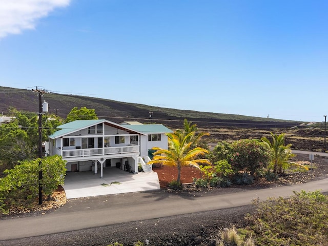 view of front facade featuring a carport and a mountain view