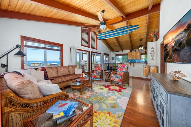 living room with vaulted ceiling with beams, dark hardwood / wood-style floors, a healthy amount of sunlight, and ceiling fan