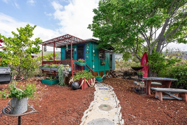 view of playground with a wooden deck and a pergola