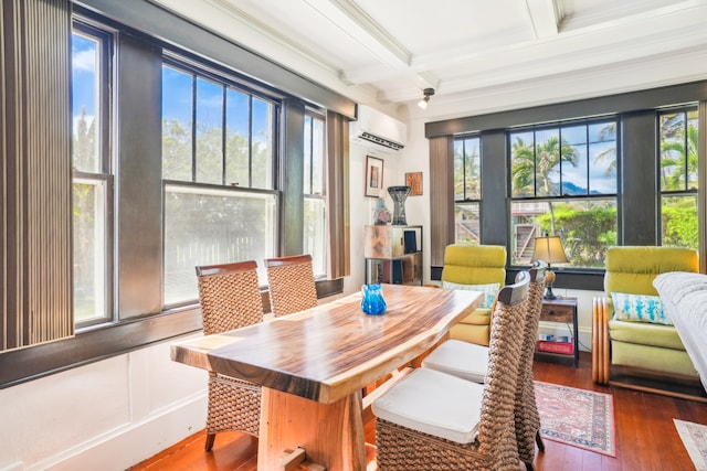 sunroom with beamed ceiling, an AC wall unit, and coffered ceiling