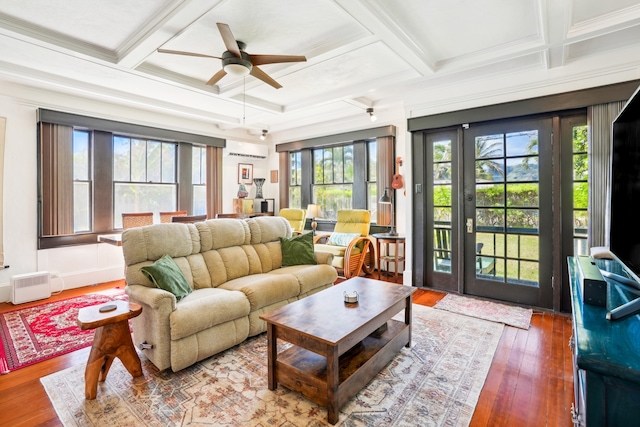 living room featuring ceiling fan, coffered ceiling, wood-type flooring, and a wealth of natural light