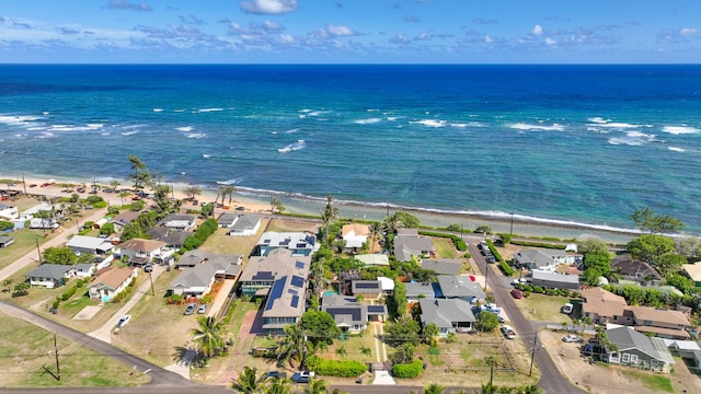 bird's eye view with a water view and a beach view