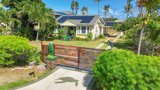 exterior space with covered porch, a front yard, and solar panels