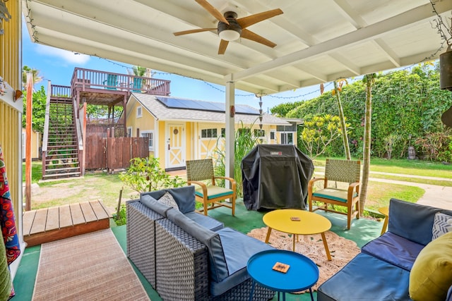 deck featuring a patio area, an outdoor living space, area for grilling, and ceiling fan