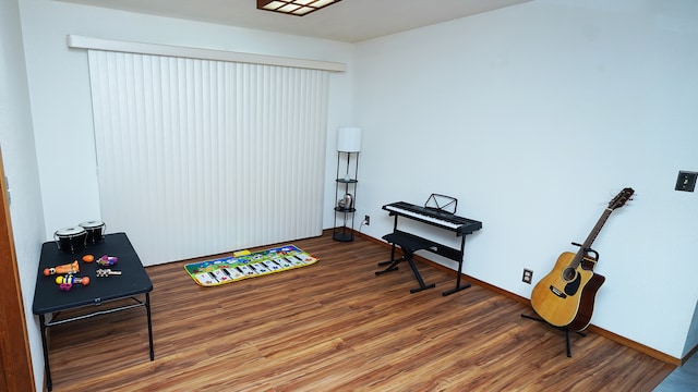 miscellaneous room featuring baseboards and wood finished floors