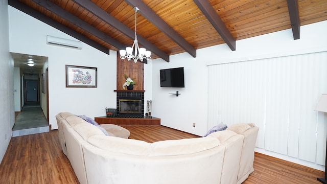 living room with beam ceiling, a chandelier, wooden ceiling, wood-type flooring, and a tile fireplace