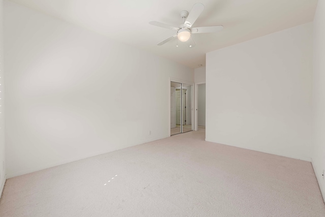 unfurnished room with carpet and ceiling fan