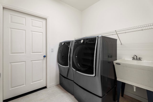 laundry area featuring separate washer and dryer and sink