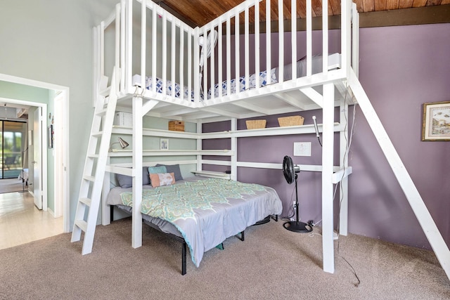 bedroom featuring carpet floors and wooden ceiling