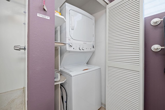 laundry area featuring stacked washer / drying machine