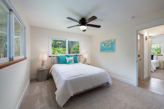 bedroom with light carpet and ceiling fan