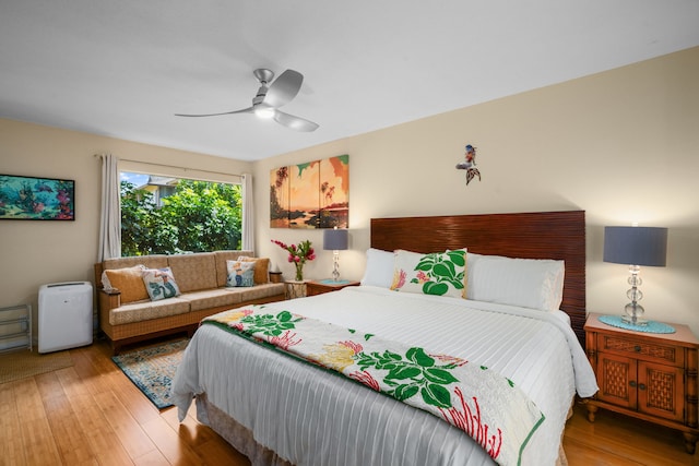 bedroom with ceiling fan and wood-type flooring