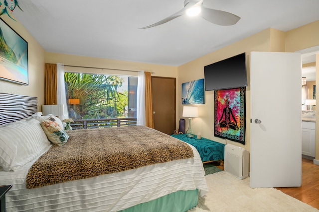 bedroom with ceiling fan, light hardwood / wood-style flooring, and ensuite bathroom