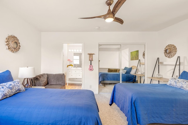 bedroom featuring light colored carpet, a closet, and ceiling fan