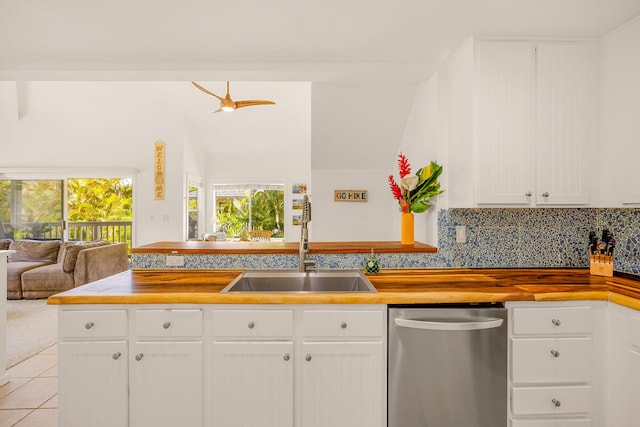 kitchen featuring white cabinets, light tile patterned floors, ceiling fan, stainless steel dishwasher, and sink