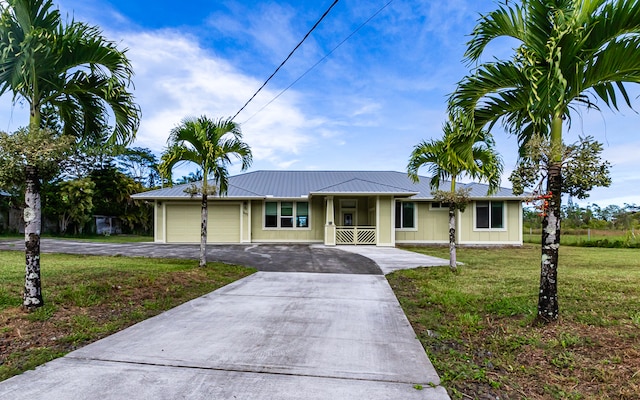 ranch-style home with a front lawn, a garage, and covered porch