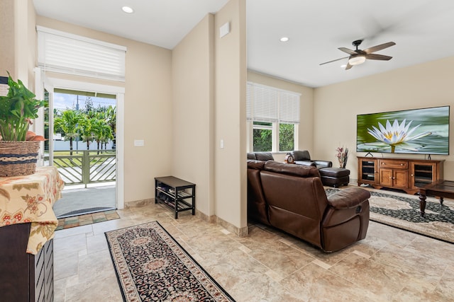 living room featuring a wealth of natural light and ceiling fan