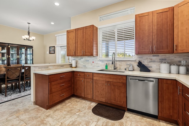 kitchen featuring sink, kitchen peninsula, dishwasher, pendant lighting, and decorative backsplash