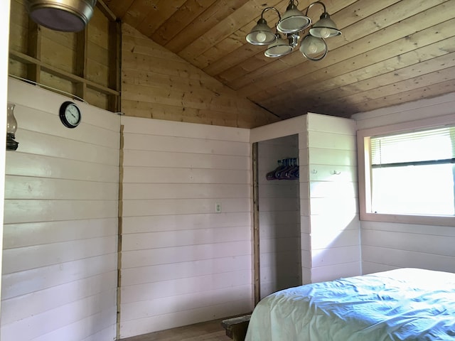 bedroom with wood-type flooring, vaulted ceiling, wooden walls, and wood ceiling