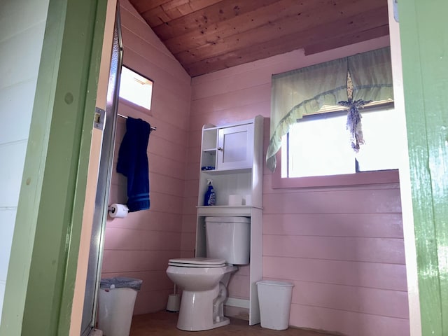 bathroom with wooden walls, vaulted ceiling, toilet, and wooden ceiling