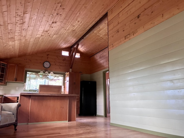 kitchen with kitchen peninsula, wood walls, light hardwood / wood-style floors, wooden ceiling, and vaulted ceiling with beams