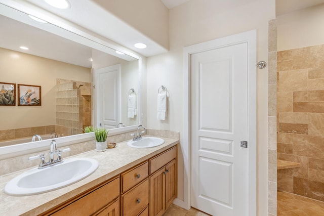 bathroom with vanity, tile patterned floors, and tiled shower