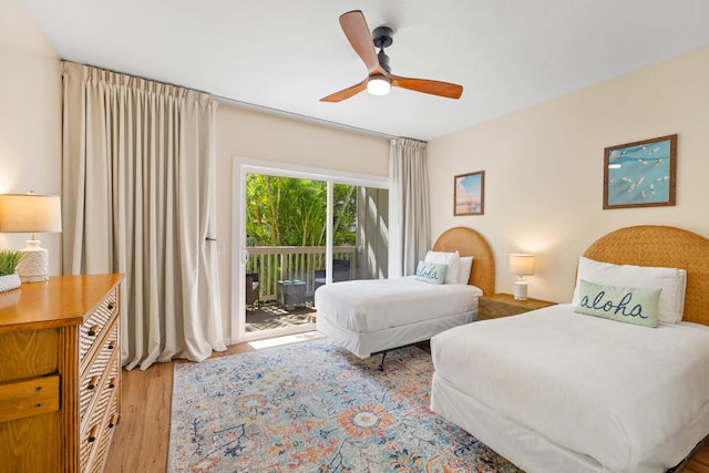 bedroom featuring access to outside, hardwood / wood-style flooring, and ceiling fan